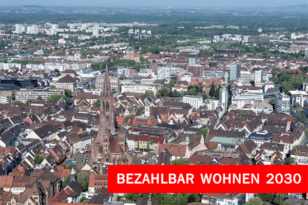 Stadtansicht mit Schriftzug "Bezahlbar Wohnen 2030"